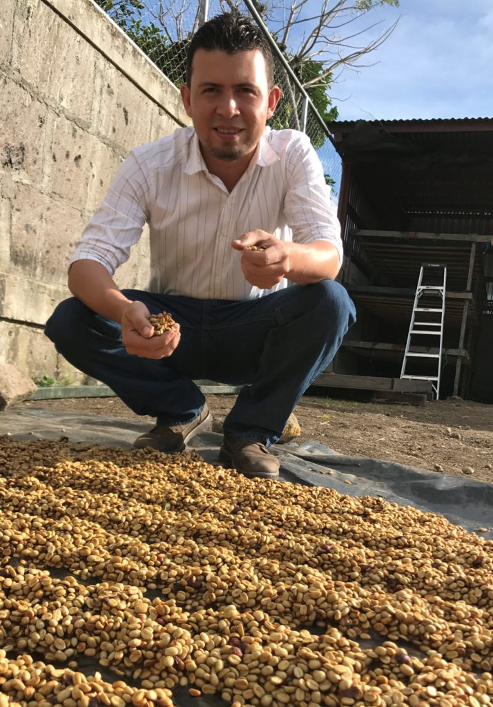 Fredman Vasquez from Finca San Rafael - drying natural coffees. Photo by CRS / Hicks